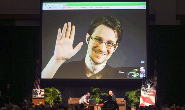 FILE - In this Feb. 14, 2015 file photo, Edward Snowden appears on a live video feed broadcast from Moscow at an event sponsored by ACLU Hawaii in Honolulu. The former National Security Agency worker, who leaked classified documents about government surveillance, started tweeting Tuesday, Sept. 29, 2015. (AP Photo/Marco Garcia, File)